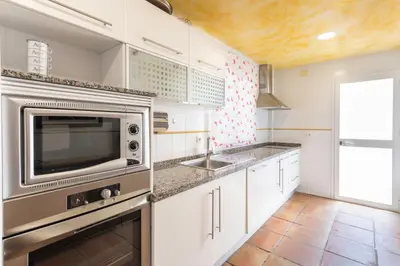 a kitchen with a sink and a microwave at Villa Golf Sanlucar in Sanlúcar de Barrameda