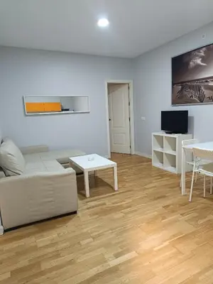 a living room with a couch and a table at Apartamentos Aloha 2 Centro El Puerto de Santa Maria in El Puerto de Santa María