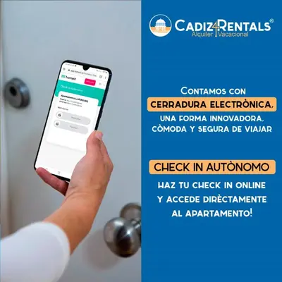 a person holding a cell phone in front of a door at Casa ALEGRIA by Cadiz4Rentals in Cádiz