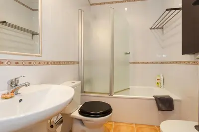 a bathroom with a sink and a toilet and a shower at Casa ALEGRIA by Cadiz4Rentals in Cádiz