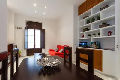 a dining room and living room with a table and chairs at Casa ALEGRIA by Cadiz4Rentals in Cádiz