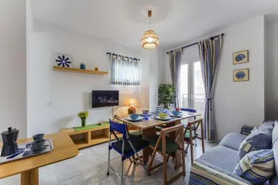 a kitchen and living room with a table and chairs at La VICTORIA Home free parking by Cadiz4Rentals in Cádiz