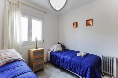 a bedroom with two beds and a window at La VICTORIA Home free parking by Cadiz4Rentals in Cádiz