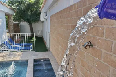 a water fountain in front of a brick wall at Chalet La Roa III in Conil de la Frontera