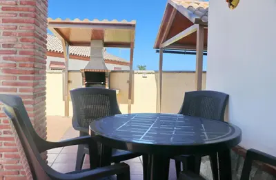 a blue table and chairs on a patio at Chalet Vigía 113 in Conil de la Frontera
