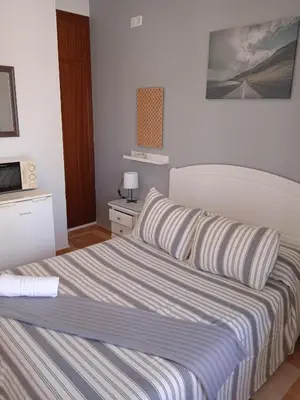a bedroom with a bed with two pillows on it at Pensión Montero in Jedula