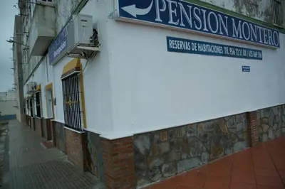 a building with a sign on the side of it at Pensión Montero in Jedula