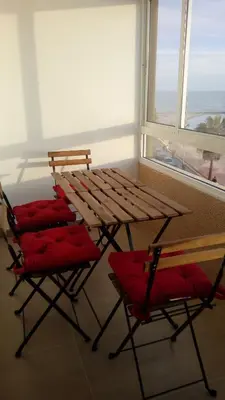 a table and two chairs in a room with a window at Apartamento Fernández Ladreda in Cádiz