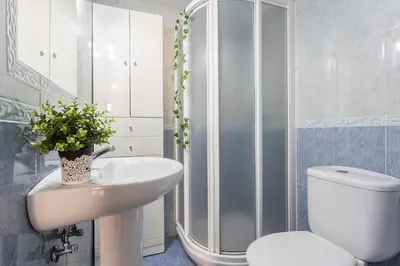 a bathroom with a toilet and a sink and a shower at Brisas Estadio Playa Victoria in Cádiz