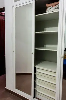 a wardrobe with a mirror in a closet at Apartamento La carraca in Chipiona