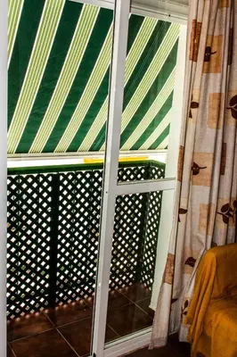 a window in a room with a view of a balcony at Apartamento La carraca in Chipiona