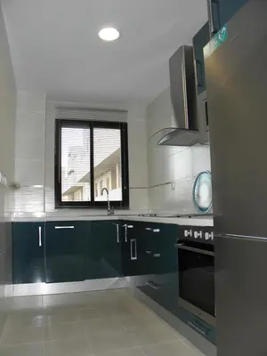 a kitchen with blue cabinets and a window at Apartamento en Jerez de la Frontera 2 in Jerez de la Frontera