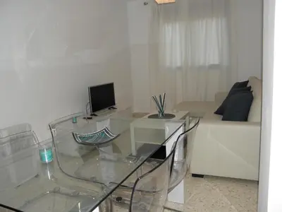 a living room with a glass table and a couch at Apartamento en Jerez de la Frontera 2 in Jerez de la Frontera