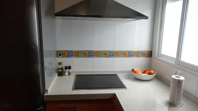 a kitchen with a sink and a bowl of fruit at Cosy Caleta Apartment in Cádiz