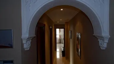 an arched hallway with an archway in a house at Cosy Caleta Apartment in Cádiz