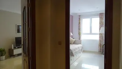 a bedroom with a bed and a window at Cosy Caleta Apartment in Cádiz