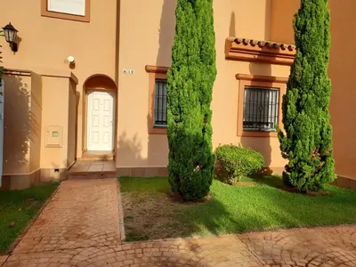 a pair of trees in front of a building at Apartamento Vespasiano in Chiclana de la Frontera