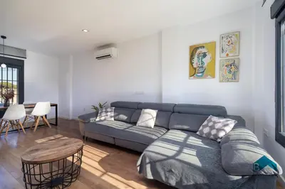 a living room with a couch and a table at Villa La Barrosa in Chiclana de la Frontera
