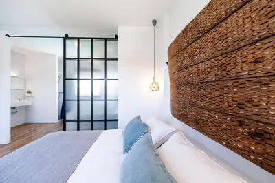 a bedroom with a large brick wall at Villa La Barrosa in Chiclana de la Frontera