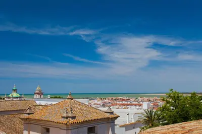 a view of a city from the roof of a building at Atico Sanlucar in Sanlúcar de Barrameda
