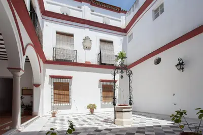 a large room with white walls and a ceiling with windows at Atico Sanlucar in Sanlúcar de Barrameda
