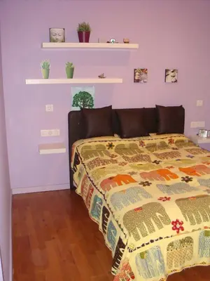 a bedroom with a bed with a colorful bedspread at La Casa del Limonero in El Puerto de Santa María