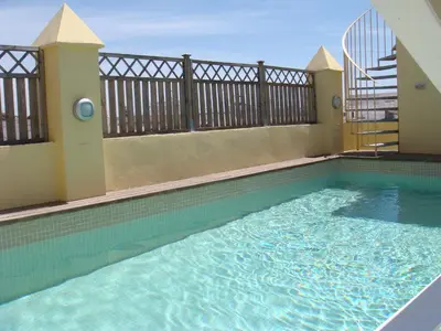 a swimming pool in the middle of a building at La Casa del Limonero in El Puerto de Santa María