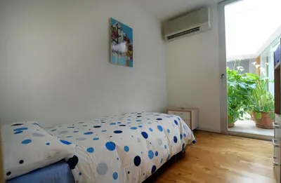 a bedroom with a bed with a polka dot sheet at La Casa del Limonero in El Puerto de Santa María