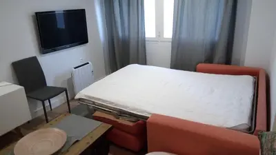 a small room with a bed and a chair at Casita Coqueta Free Parking in Cádiz