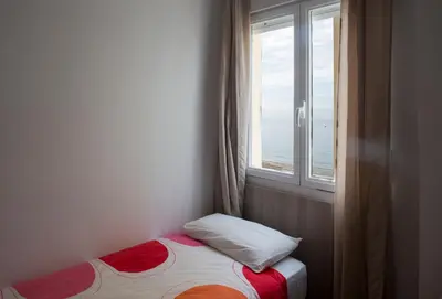 a small bed in a room with a window at Casita Coqueta Free Parking in Cádiz
