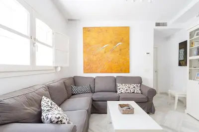 a living room with a couch and a table at El Mirador del CAMPANARIO by Cadiz4Rentals in Cádiz