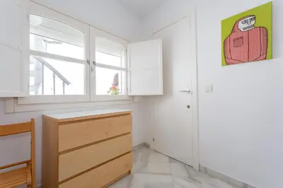 a kitchen with white cabinets and a window at El Mirador del CAMPANARIO by Cadiz4Rentals in Cádiz