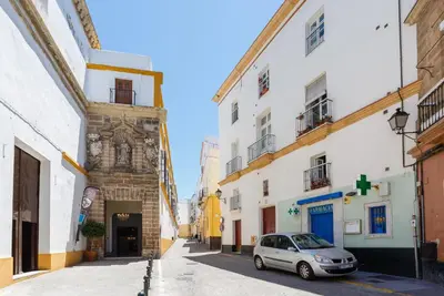 a car parked in a street between two buildings at El Mirador del CAMPANARIO by Cadiz4Rentals in Cádiz