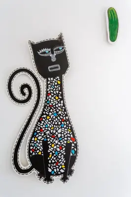 a black cat wearing a tie with colorful buttons at El Mirador del CAMPANARIO by Cadiz4Rentals in Cádiz
