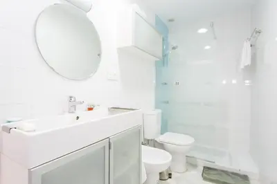 a white bathroom with a sink and a toilet at El Mirador del CAMPANARIO by Cadiz4Rentals in Cádiz