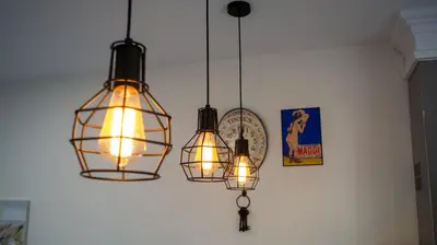 a group of three lights hanging from a ceiling at Casita de María in El Puerto de Santa María