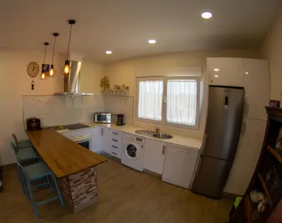 a kitchen with a sink and a refrigerator at Casita de María in El Puerto de Santa María