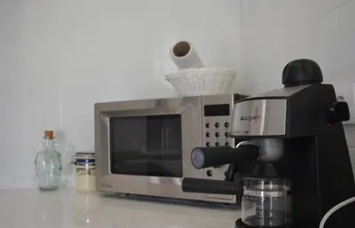 a microwave sitting on a counter next to a coffee maker at Casita de María in El Puerto de Santa María