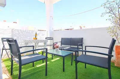 a group of chairs and a table on a patio at El Atico de las MARINAS free Parking by Cadiz4Rentals in Cádiz