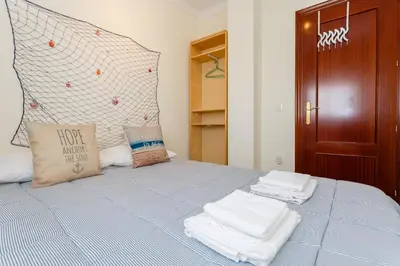 a bedroom with a bed with towels on it at El Atico de las MARINAS free Parking by Cadiz4Rentals in Cádiz