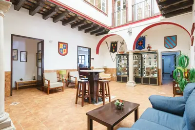 a living room with a blue couch and a table at Hotel Carlos V Jerez by Vivere Stays in Jerez de la Frontera