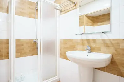 a white bathroom with a sink and a shower at Hotel Carlos V Jerez by Vivere Stays in Jerez de la Frontera