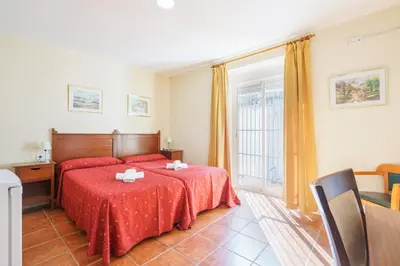 a bedroom with a red bed and a window at Hotel Carlos V Jerez by Vivere Stays in Jerez de la Frontera