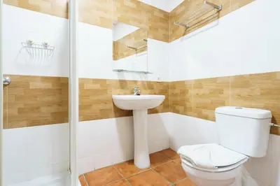 a bathroom with a toilet and a sink at Hotel Carlos V Jerez by Vivere Stays in Jerez de la Frontera