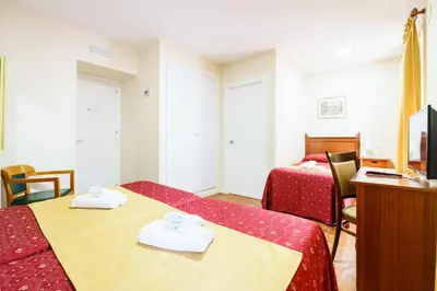 a hotel room with two beds and a television at Hotel Carlos V Jerez by Vivere Stays in Jerez de la Frontera