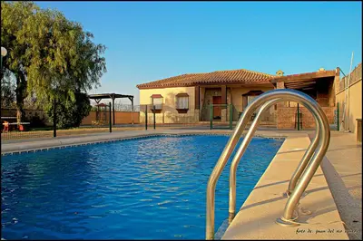 a swimming pool with a water slide in front of a building at Mi Oasis in Conil de la Frontera