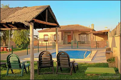 a group of chairs sitting next to a swimming pool at Mi Oasis in Conil de la Frontera