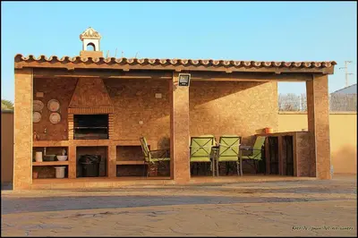a building with chairs in the back of it at Mi Oasis in Conil de la Frontera