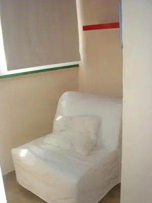 a white chair in a corner of a room at Chalet Pto Sta Maria, SOLO FAMILIAS in El Puerto de Santa María