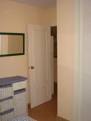 a room with a white door and a mirror at Chalet Pto Sta Maria, SOLO FAMILIAS in El Puerto de Santa María